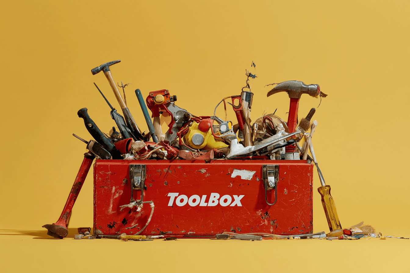 A red toolbox filled with tools on a yellow background